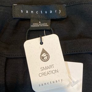 Sanctuary sleeveless tank with peek hole opening.